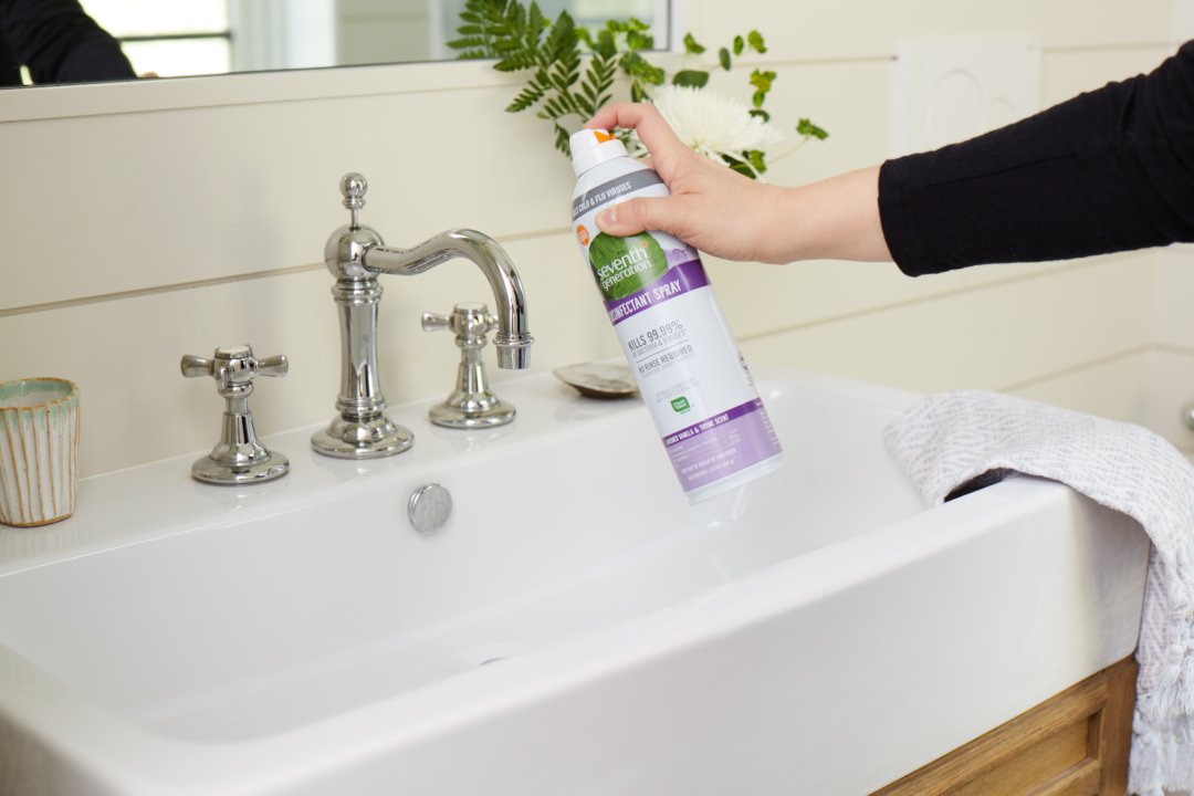 disinfectant spray being sprayed on bathroom vanity