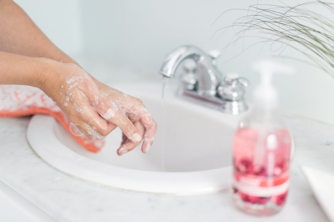 handwashing in bathroom sink