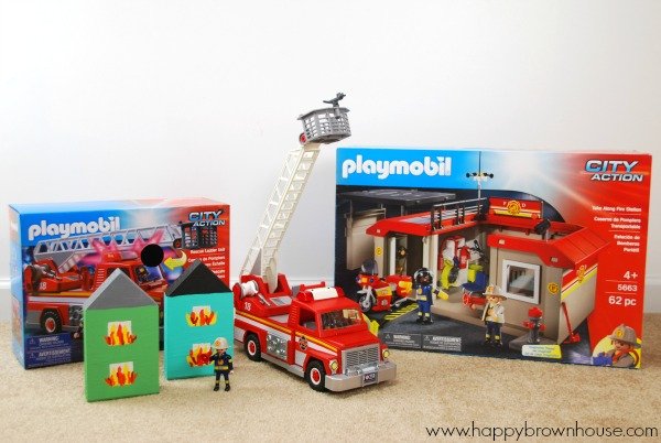 PLAYMOBIL toys in boxes, fire truck with ladder and block houses craft