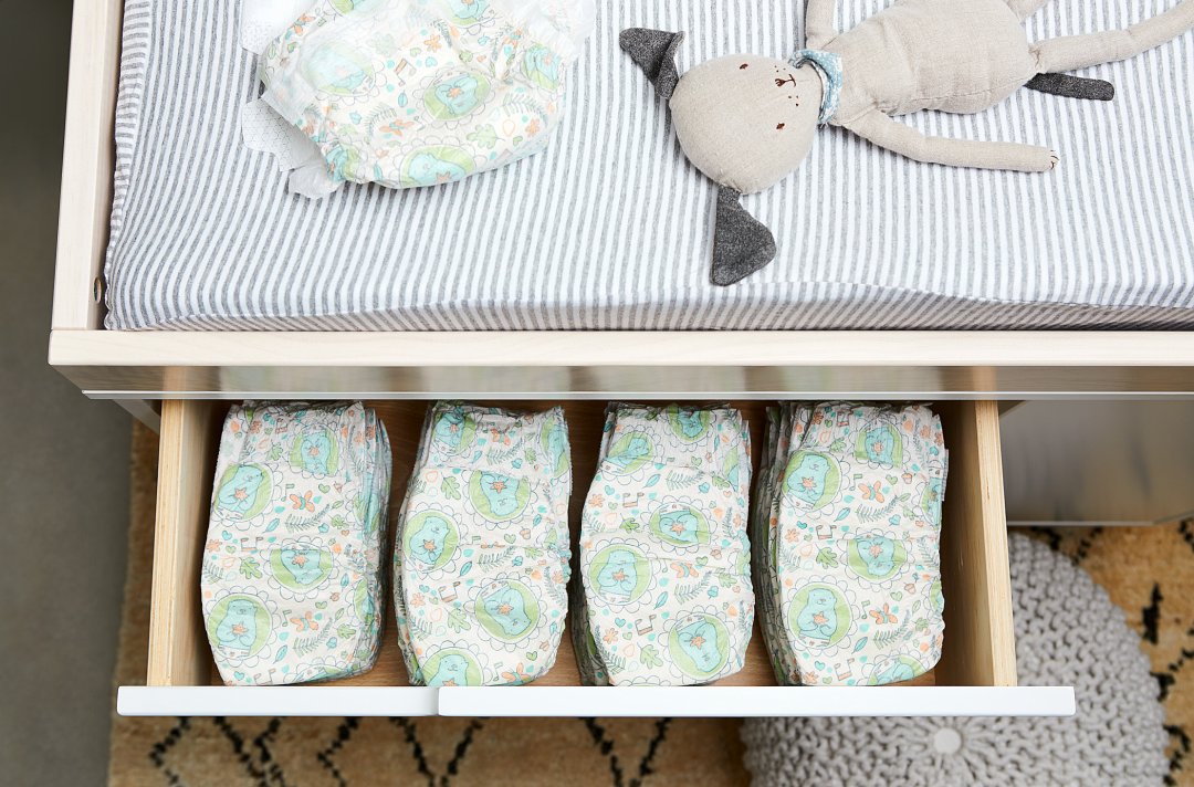 nursery changing table showing drawer of diapers