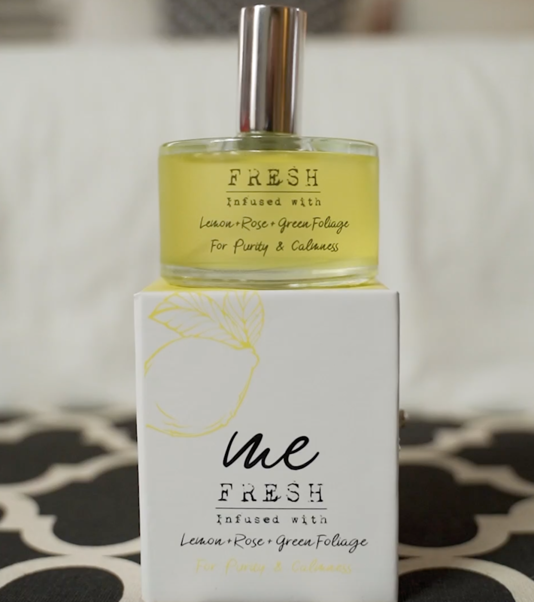 A bottle of Fresh Lemon and Rose scented perfume.