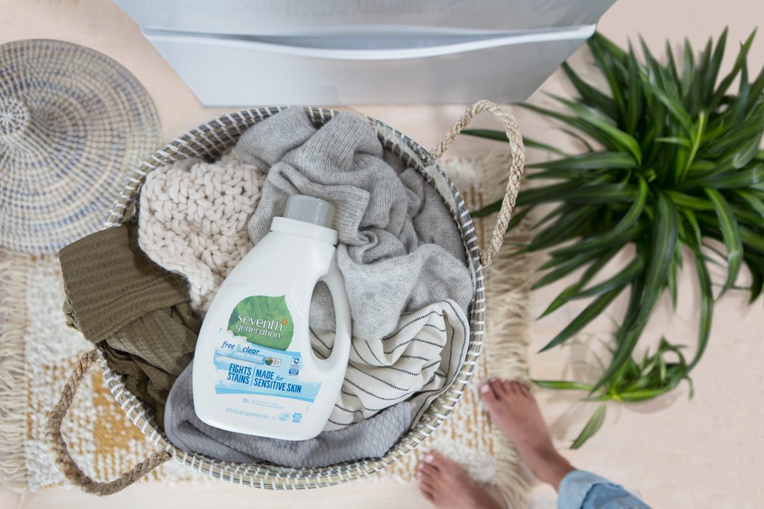 Free and Clear Laundry Bottle in a hamper of clothes