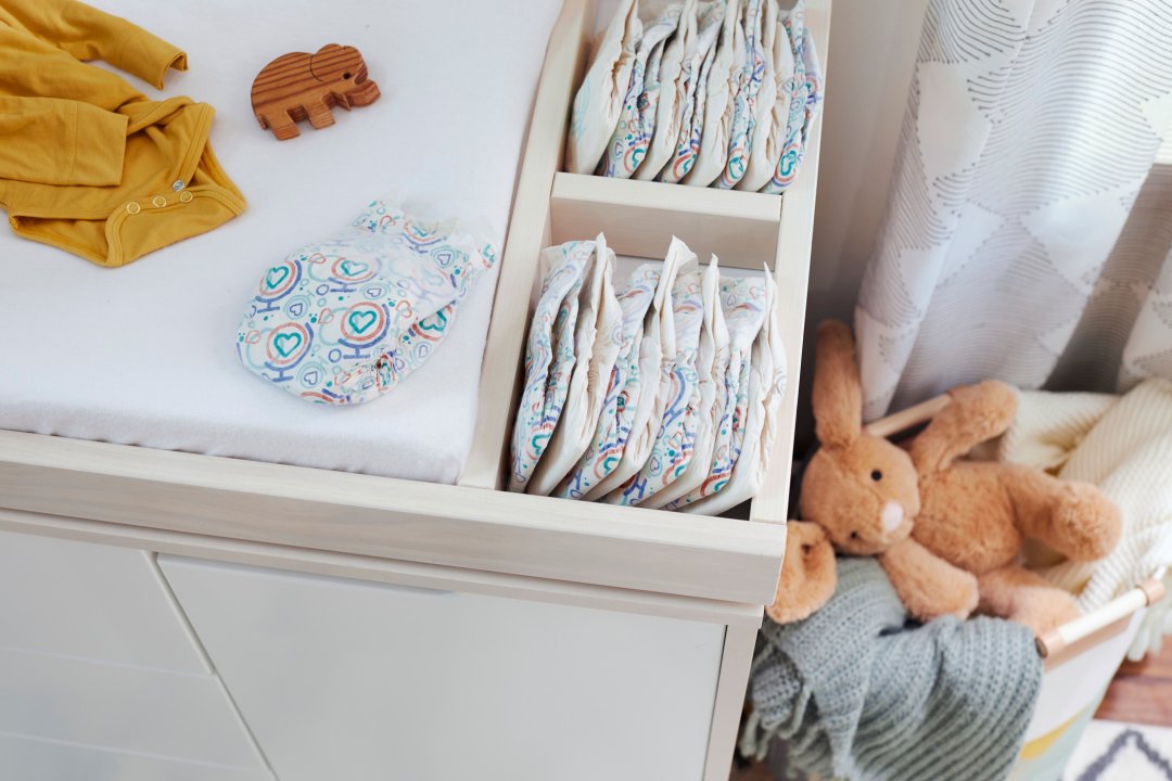 new baby diapers in changing table drawer