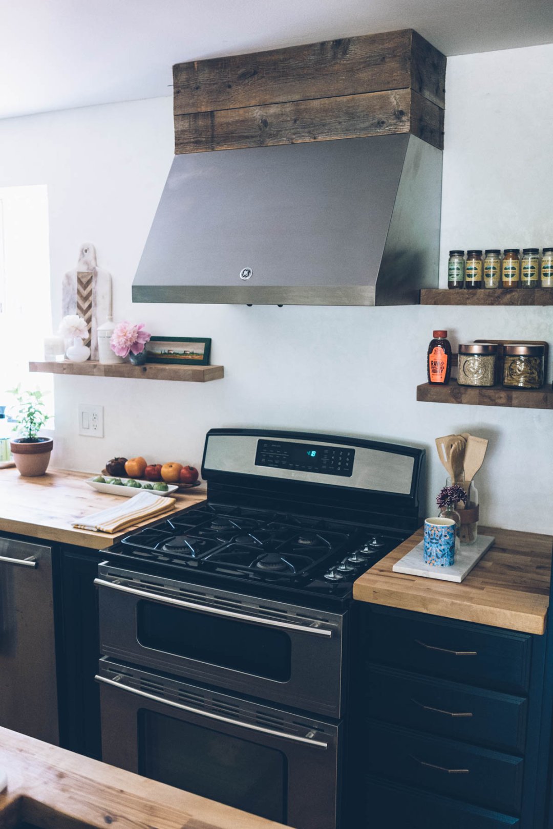 Kitchen renovation with new range hood and DIY palette wood duct cover