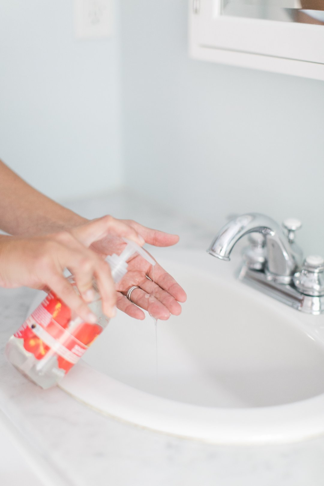 hand wash being used in bathroom sink